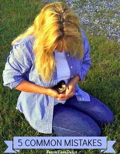 a woman sitting on the grass holding a kitten in her lap with text overlay that reads, 5 common mistakes