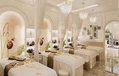 a room with several tables covered in white linens