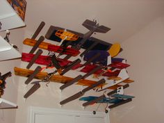 there are many toy airplanes hanging from the ceiling