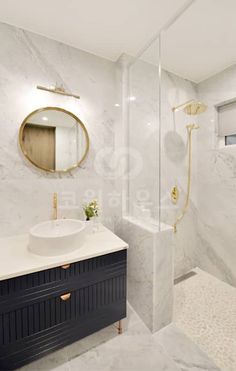 a bathroom with white marble walls and floor