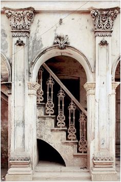 an old building with some stairs going into it