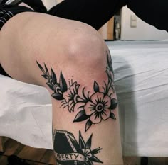 a woman's leg with flowers on it and the word pretty written in black ink