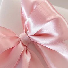 a pink bow on top of a white box