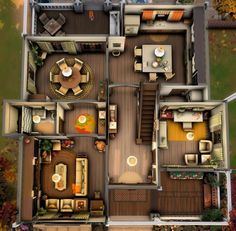 an aerial view of a house from above with furniture in the living room and dining area