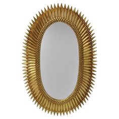 an oval mirror with metal spikes on the edges and a white back ground, isolated against a white background