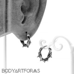 a pair of earrings is shown in black and white