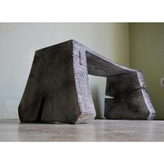 two pieces of wood sitting on top of a floor next to each other in front of a wall