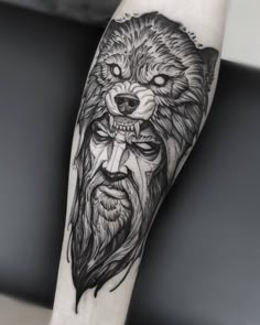 a man's arm with a wolf tattoo on it