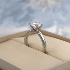 an engagement ring is sitting in a box