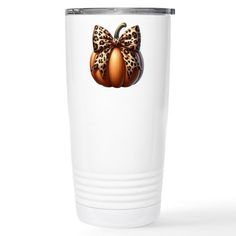 a white tumbler cup with a leopard print bow and pumpkins on the side