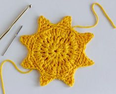 the crochet star is next to two knitting needles