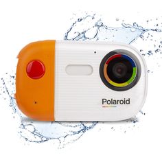 an orange and white polaroid camera with water splashing around it's edges