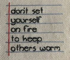 a piece of fabric with the words don't set yourself on fire to keep others warm