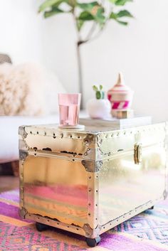 a trunk sitting on top of a colorful rug