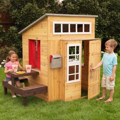 a small wooden house sitting in the grass