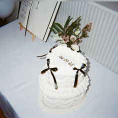 a wedding cake on a table with flowers