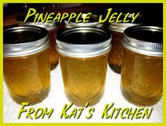 four mason jars with pineapple jelly in them sitting on a white towel and the words, from kat's kitchen