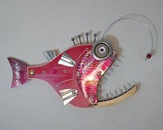 a red fish sculpture hanging on the wall