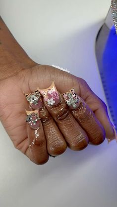 a person holding some kind of ring in their hand with other rings on it's fingers