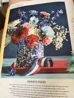 an open magazine with flowers in a vase on the cover and other things inside it