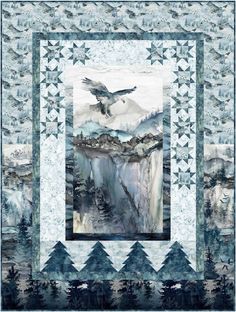 a quilt with an eagle flying over a mountain