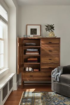 a living room with a couch, chair and bookcase