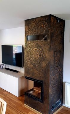 a living room with a fireplace and tv on the wall in front of it's entertainment center