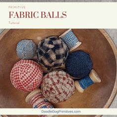 a wooden bowl filled with different types of fabric balls