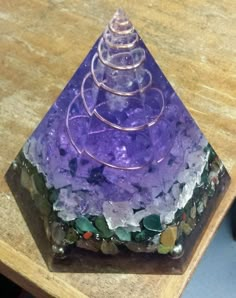 a purple object sitting on top of a wooden table