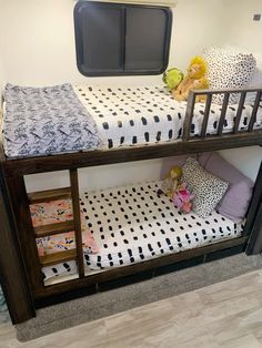 a bunk bed with black and white polka dot sheets