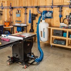 a workbench in a garage with tools and equipment on the wall behind it