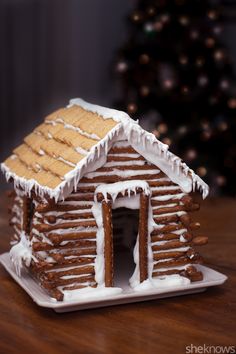 a gingerbread house with icing on the roof