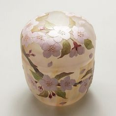 a glass box with flowers painted on it