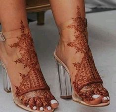 a woman's feet with hennap painted on her legs and heels,