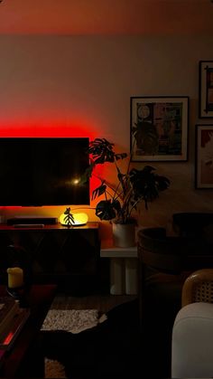 a living room filled with furniture and a flat screen tv sitting on top of a wooden table