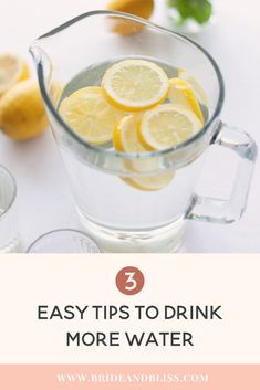 a pitcher filled with lemons sitting on top of a table