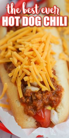 the best ever hot dog chili is in a paper container with cheese on top and ketchup on the side