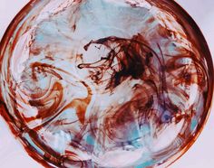 a glass plate with brown and blue swirls on it