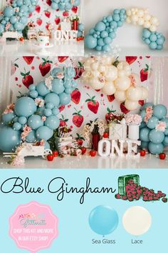 blue and white balloons are on display in front of a backdrop with strawberrys, one is