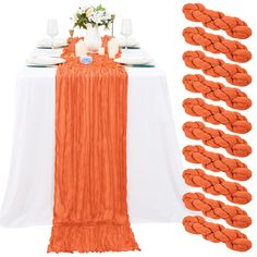 the table is set with orange and white linens