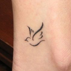 a small black bird tattoo on the neck