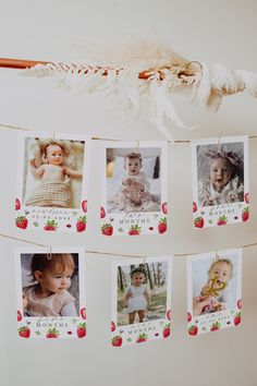 a bunch of pictures hanging from a clothes line with strawberries on the clothesline