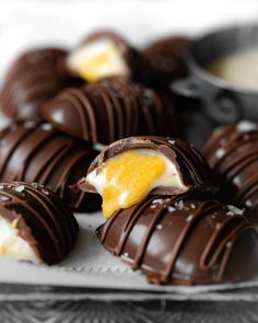 chocolate covered desserts on a plate with dipping sauce