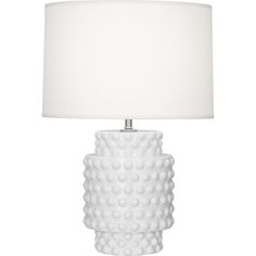 a white table lamp with a white shade on the base and a white drum light