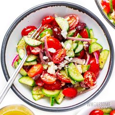 a bowl filled with cucumber, tomato and onion salad