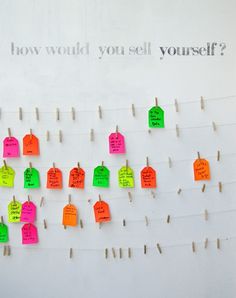 colorful notes pinned to clothes pins on a white board with the words how would you sell yourself?