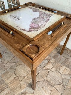 a wooden table with an old map on it