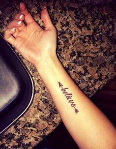 a woman's arm with an arrow tattoo on it and the word hope written in cursive font