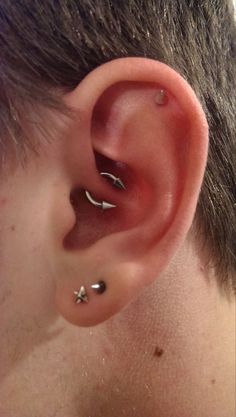 a man with three piercings on his ear