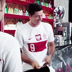 two young men standing in front of a counter